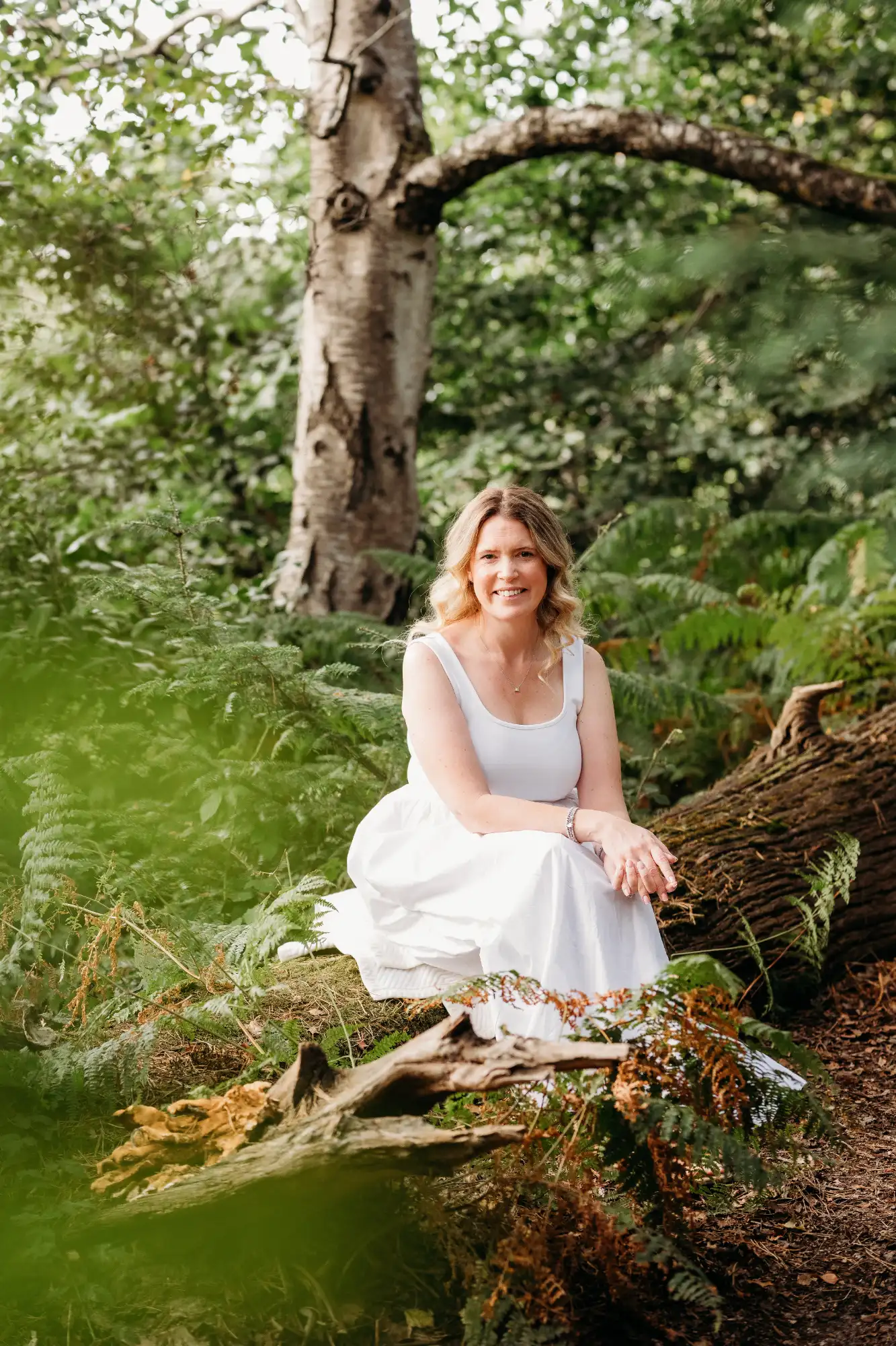 Linsey sitting peacefully in a natural forest setting